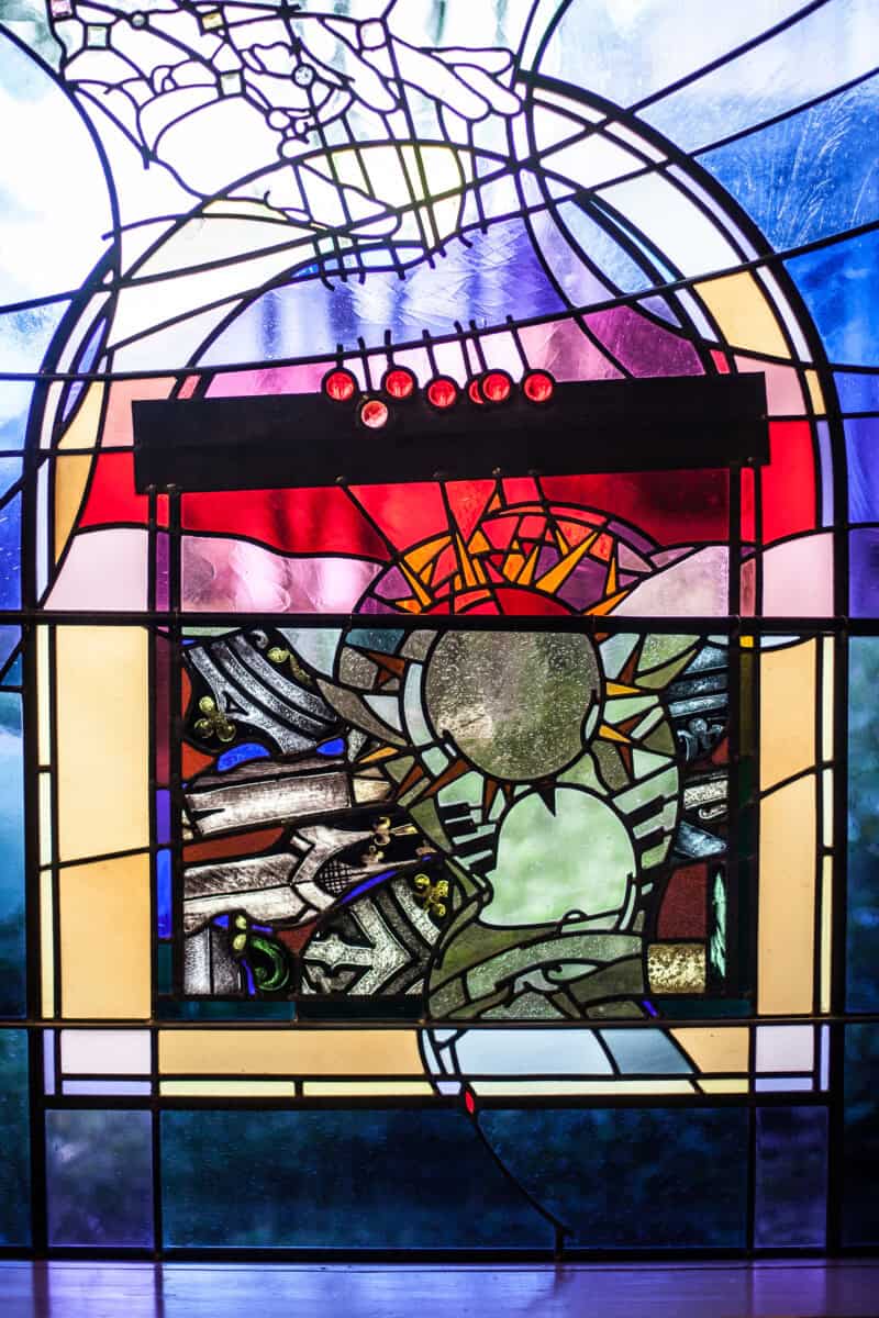 Stained glass window at First Presbyterian Baton Rouge with geometric shapes, abstract design, and vibrant red, yellow, and blue colors.