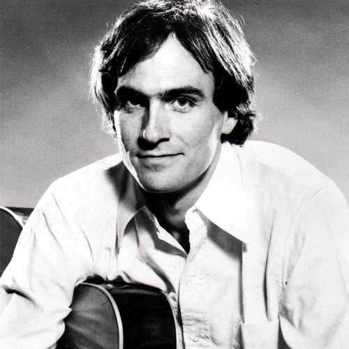 Black-and-white photo of a man with medium-length hair in a button-down shirt holding an acoustic guitar at First Presbyterian Baton Rouge.