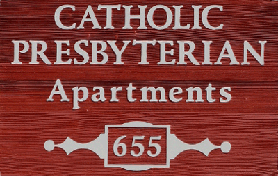 A red sign with white text reads "Catholic Presbyterian Apartments 655" near First Presbyterian Baton Rouge, with decorative accents.
