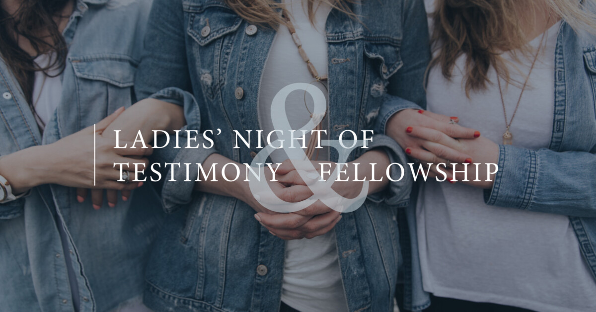 Three women in casual denim and white tops stand side by side, arms linked, celebrating a Women's Night of Testimony & Fellowship.
