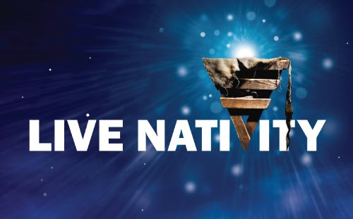 Text "LIVE NATIVITY" appears over a blue starburst background, with a wooden manger and cloth overlaying the letter "V," highlighting live nativity cast members.