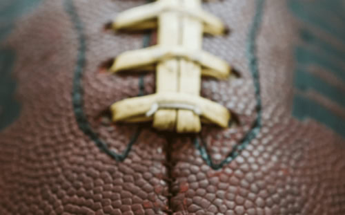 Close-up view of a brown football, perfect for a Men's Ministry Football Watch Party at First Presbyterian.