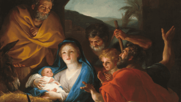A woman holds a baby surrounded by three men and a child in soft light, capturing a serene moment of mid-week Advent worship.